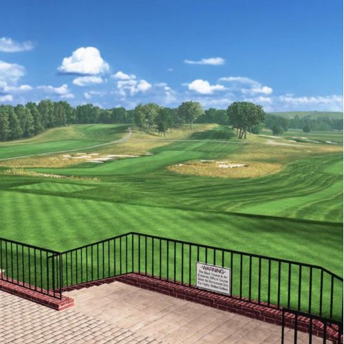 Bethpage Black Golf course with green fairways and trees under a blue sky.