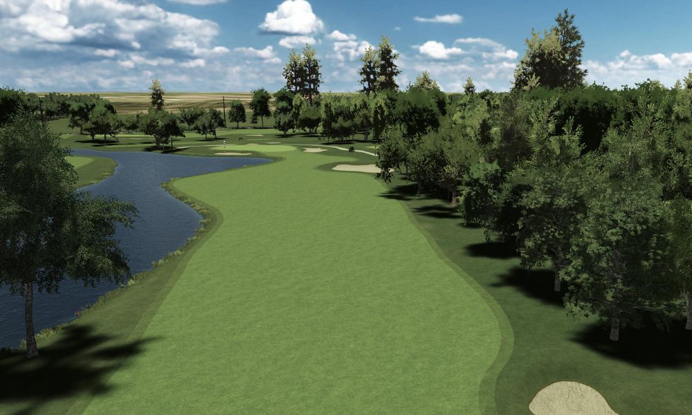 Golf course with green fairway, trees, and a body of water under a blue sky.