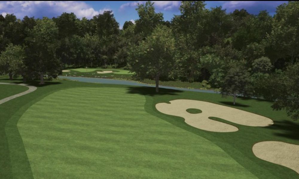 Golf course with green grass and trees under a blue sky