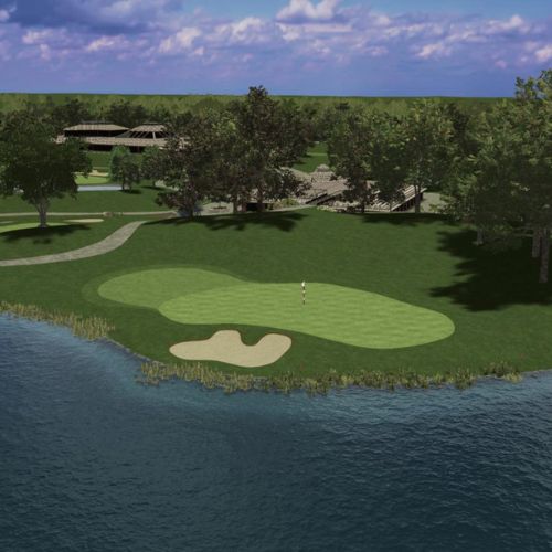 Golf course with a green and sand bunker near a body of water, surrounded by trees.