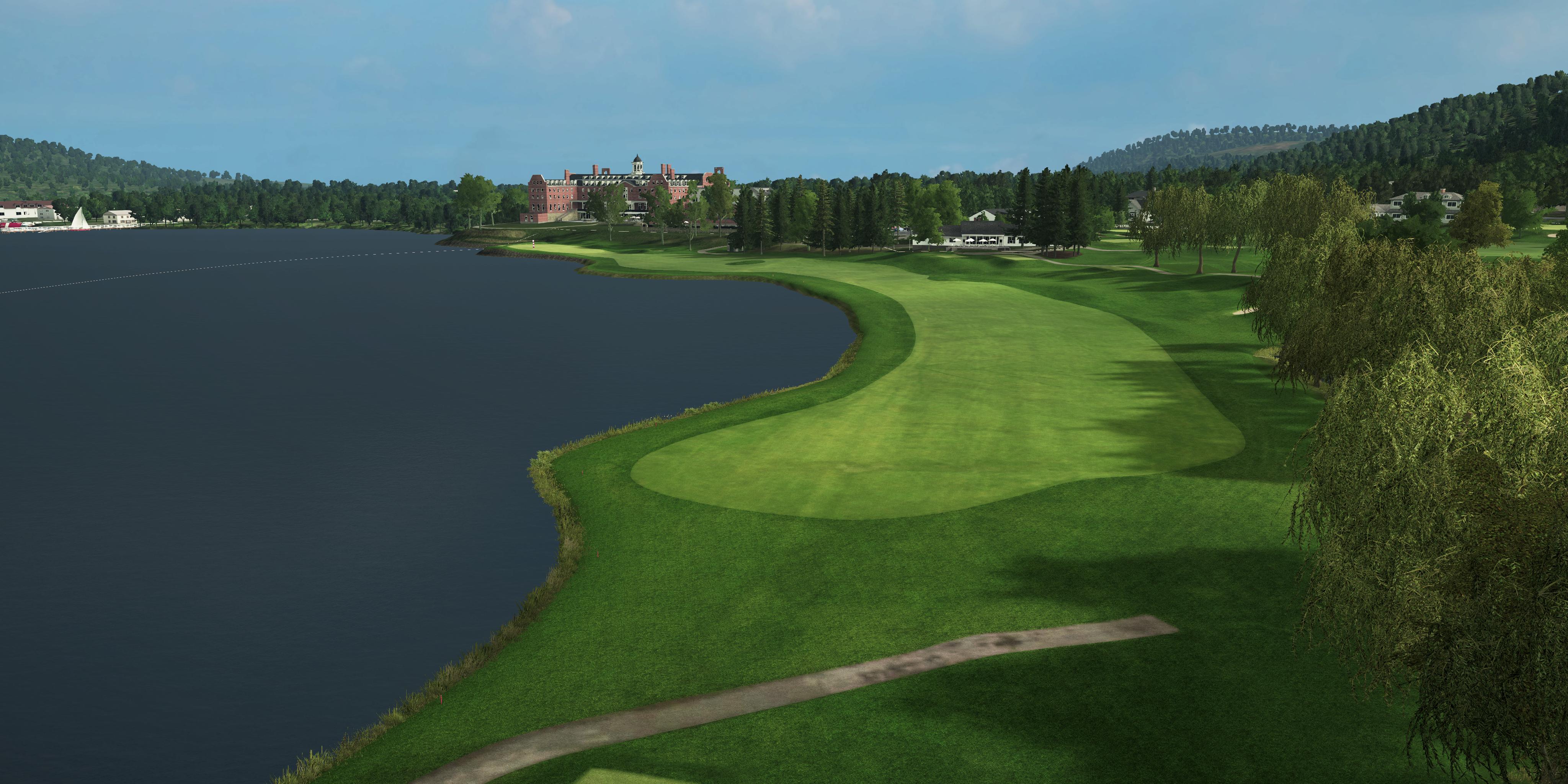 Golf course with a lake and clubhouse in the background