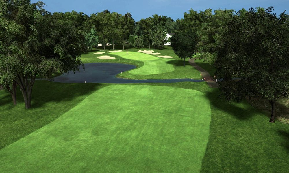 Golf course with green grass, trees, and a water hazard.