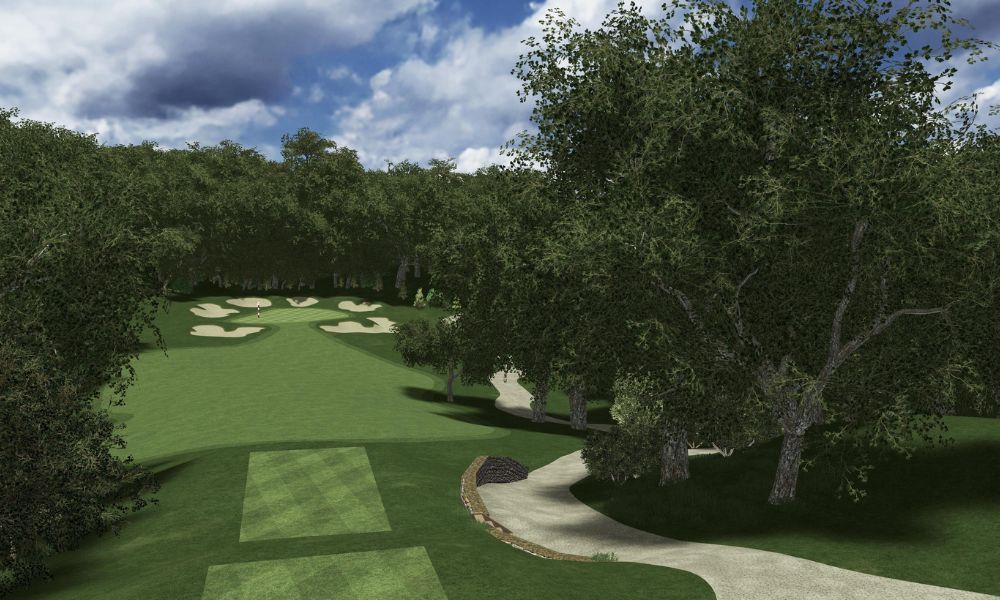 Golf course with green grass, trees, and a clear sky