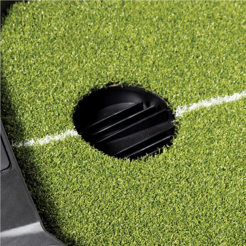 Golf hole on a green putting surface with a white line