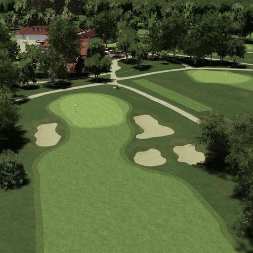 Golf course with green fairway and sand bunkers, surrounded by trees and buildings.