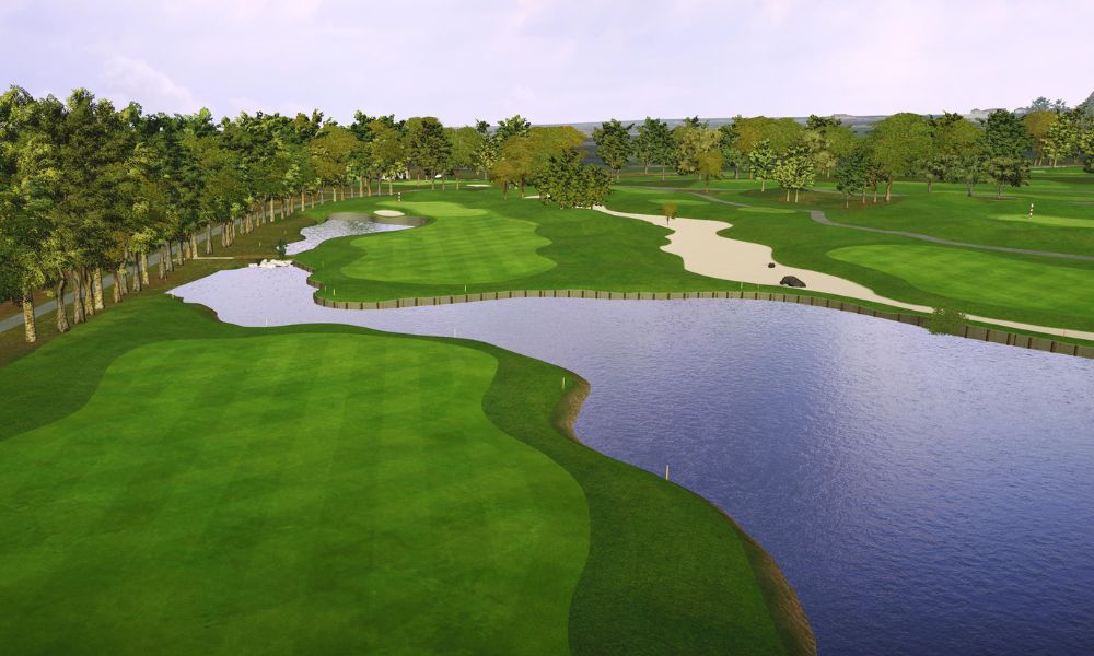Golf course with green grass, water, and trees under a clear sky