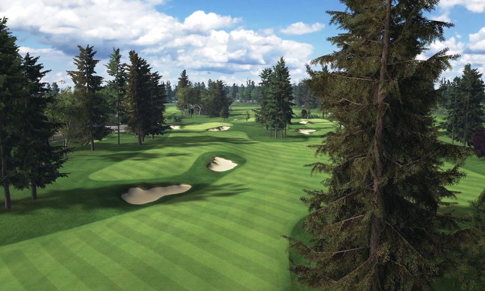 Golf course with green grass, trees, and a clear sky