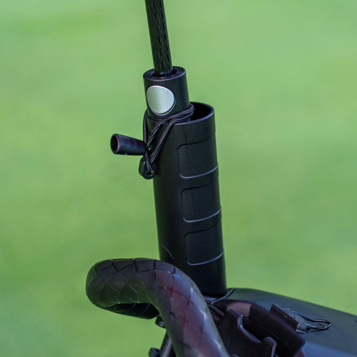 Close-up detail of the Motocaddy Nitron umbrella holder attachment, showcasing the secure locking mechanism and durable construction for your golf cart.