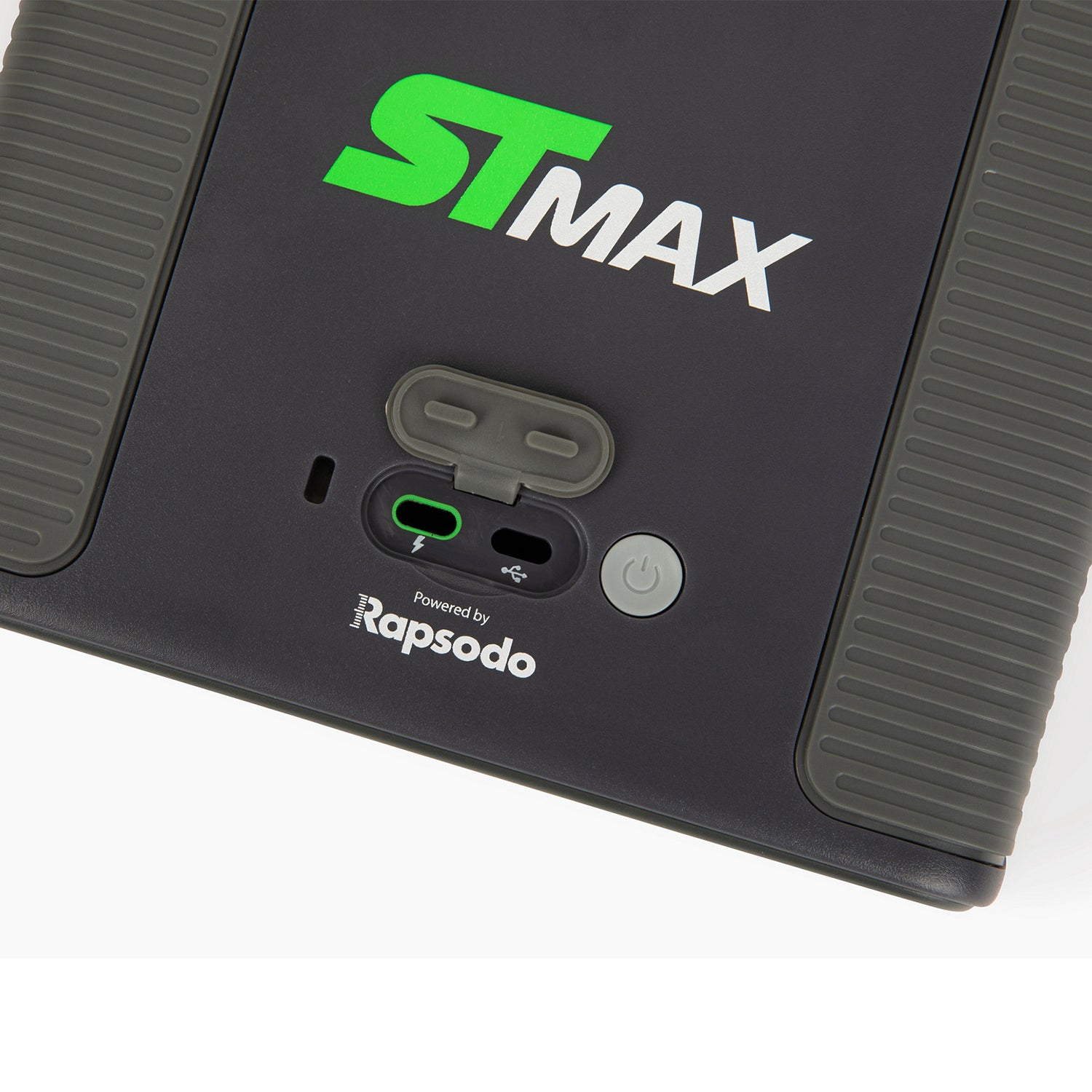 SkyTrak ST-MAX launch monitor control panel showing an open rubber protective cover over the USB-C charging port, an LED indicator light, and power button interface.